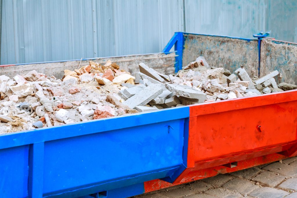 Full construction waste at construction site Waste container, rubbish bricks. Soft focus.